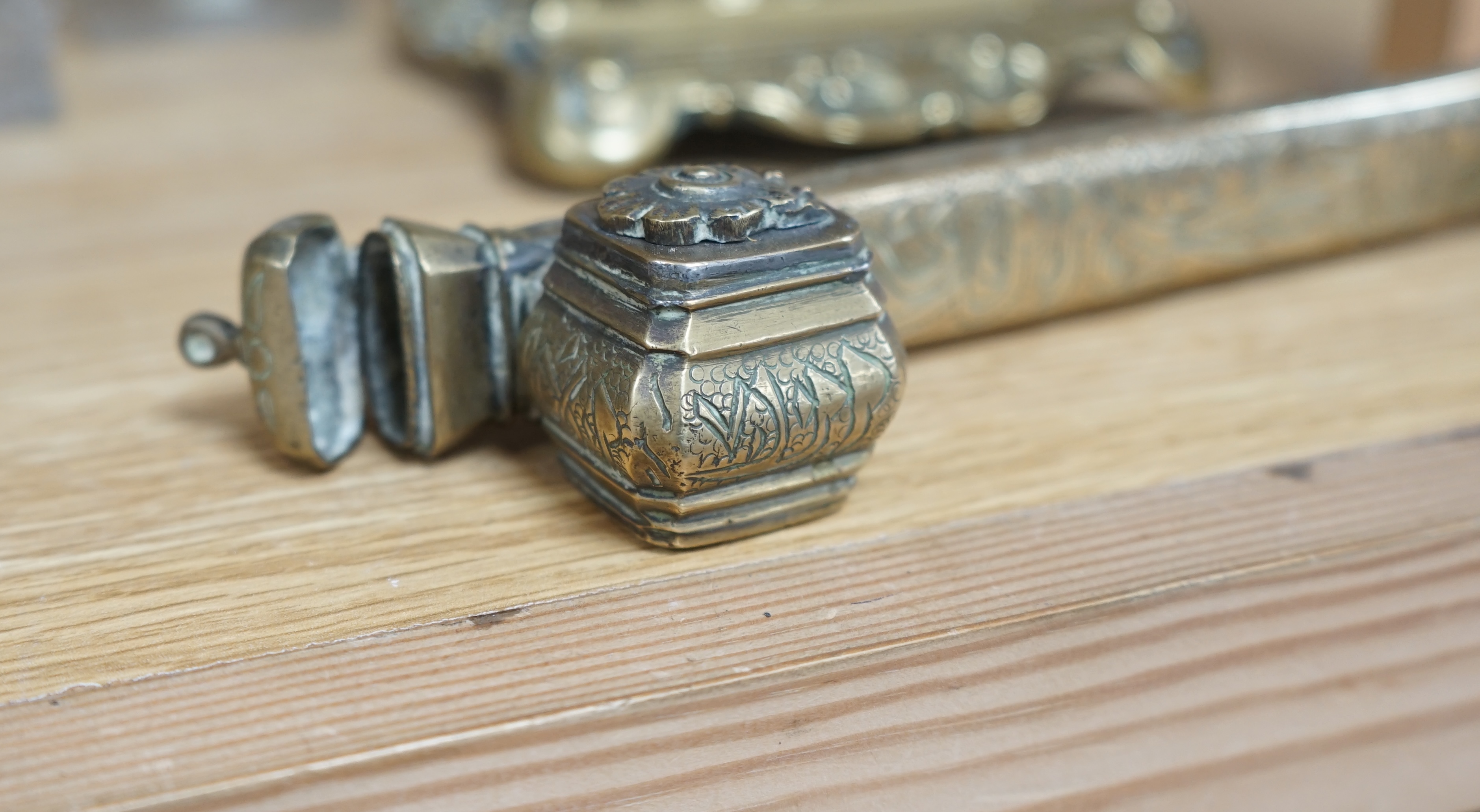 A 19th century Persian brass scribe set, a cast brass inkwell, three other inkwells, largest 24cm in length (5) Condition - poor to fair